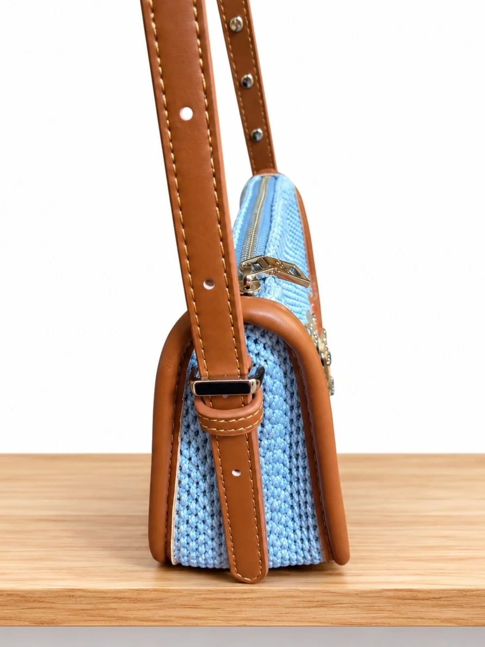 Light Blue Woven Shoulder Bag with Brown Leather Trim and Floral Accent